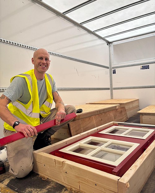 Jim next to the windows in a lorry