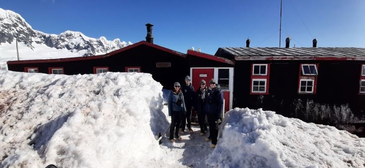 The team outside the cabin