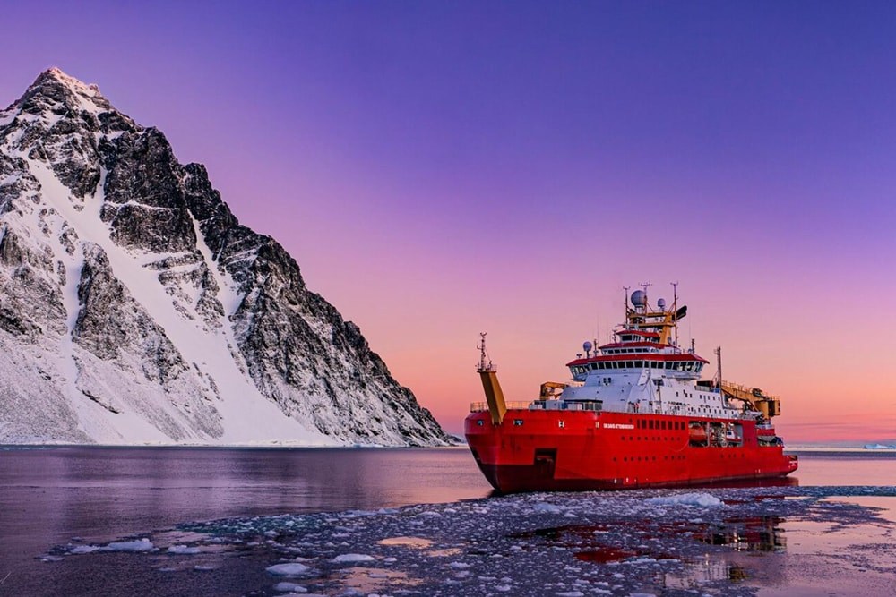 The red SDA in low twilight with an icy mountain in the background