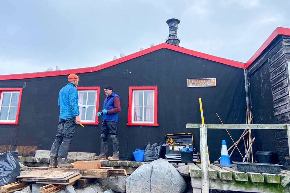 Two carpenters and tools out side Bransfield House