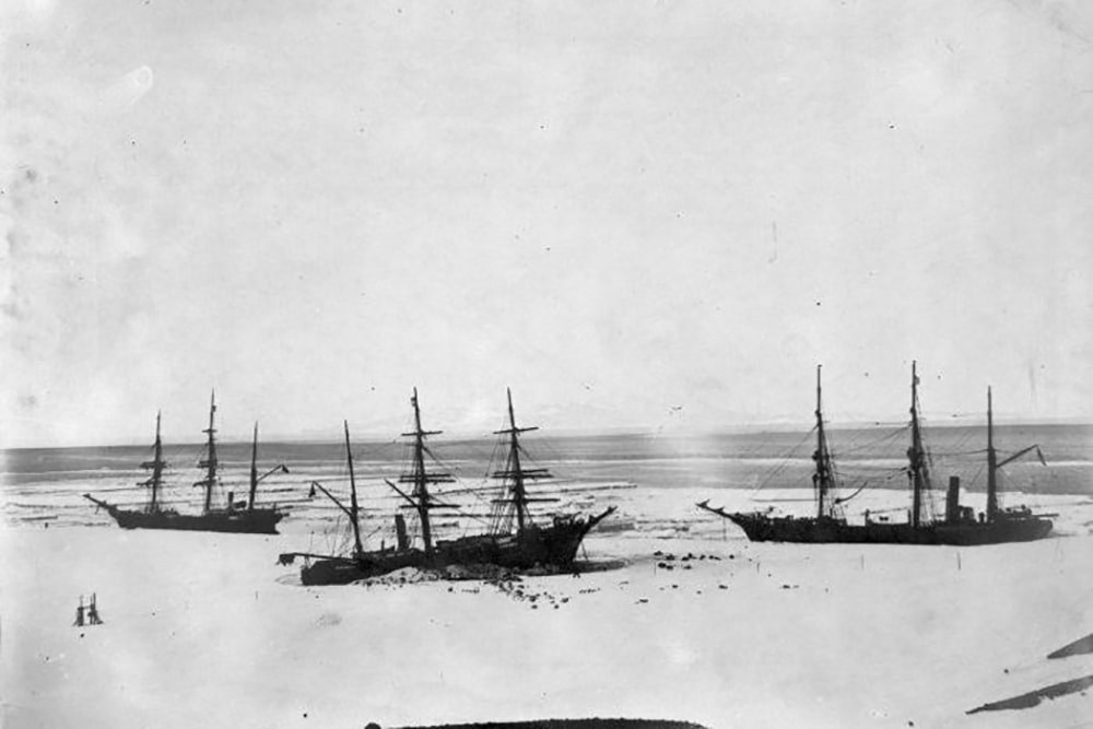 b&W photo of the rss discovery tarpped in ice - an historic Antarctic ship